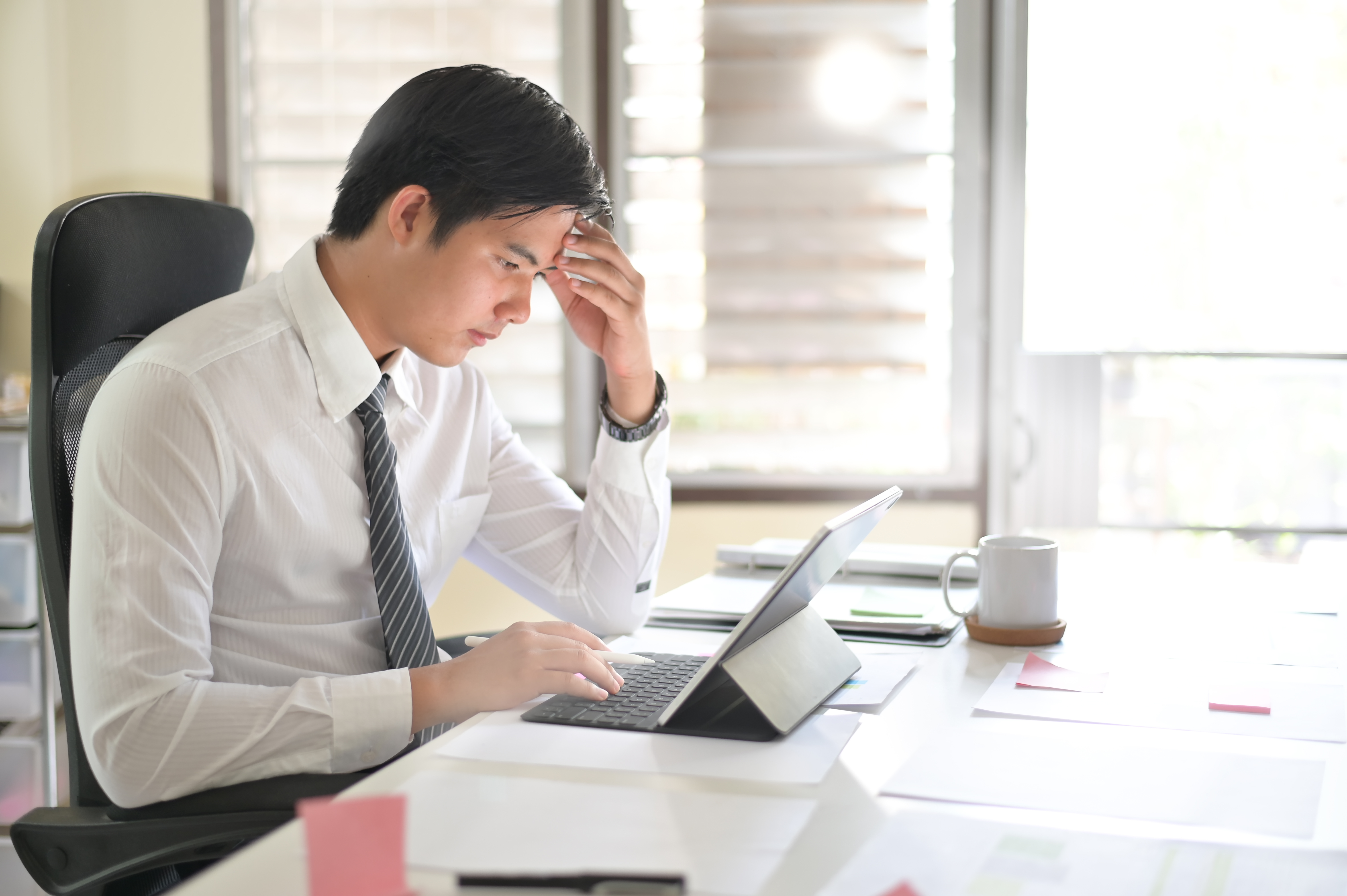 Businessman analyzing financial statistics displayed on the tablet screen