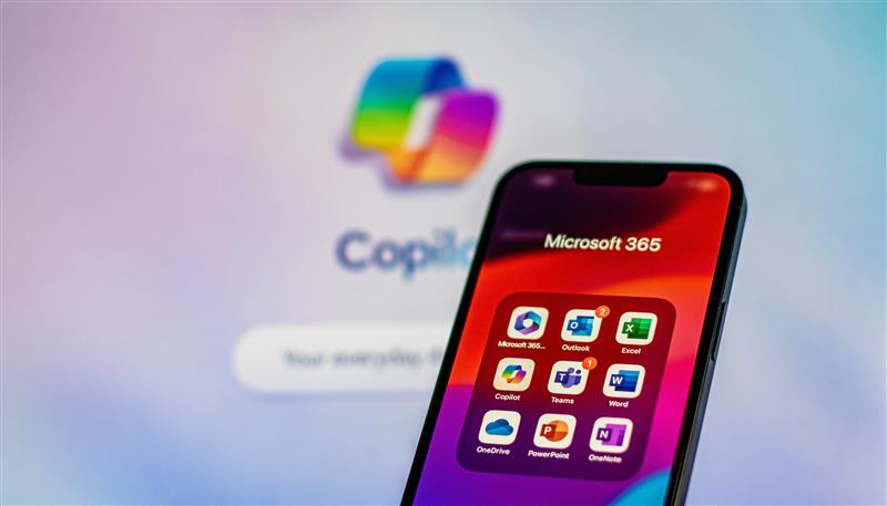 Smartphone displays Microsoft 365 apps, including Word and Excel. Background shows a blurred "Copilot" logo in vibrant colors.
